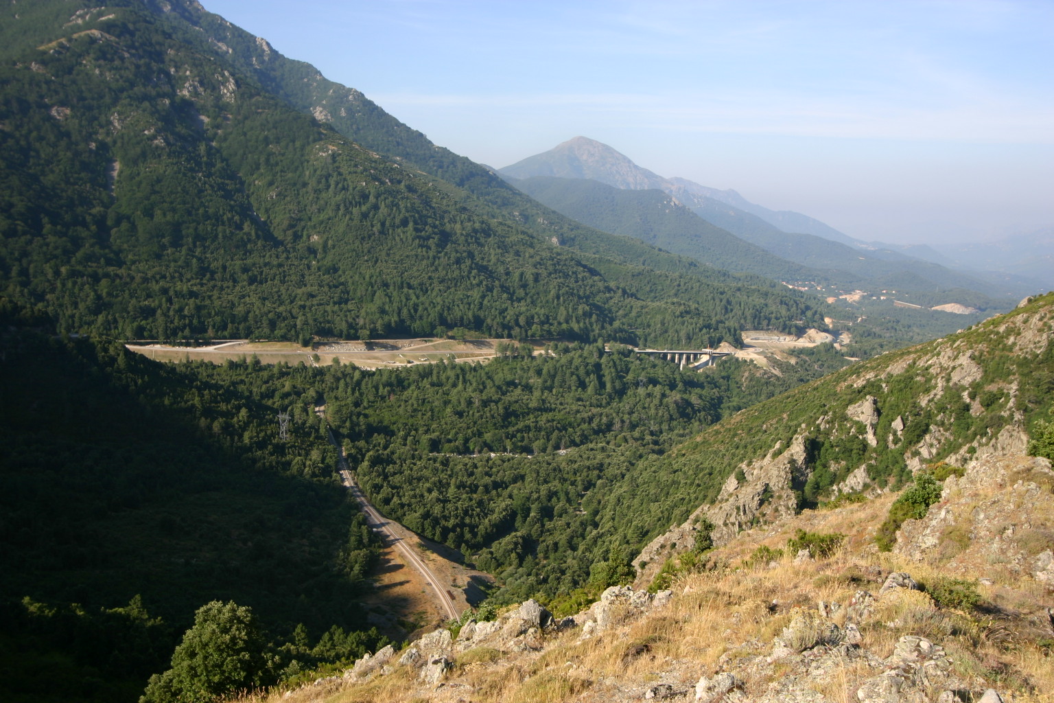 Depuis les hauteurs menant au col de Vizzavona, on domine la vallée de la Gravona. Illustre l'entrelacs des voies de communication